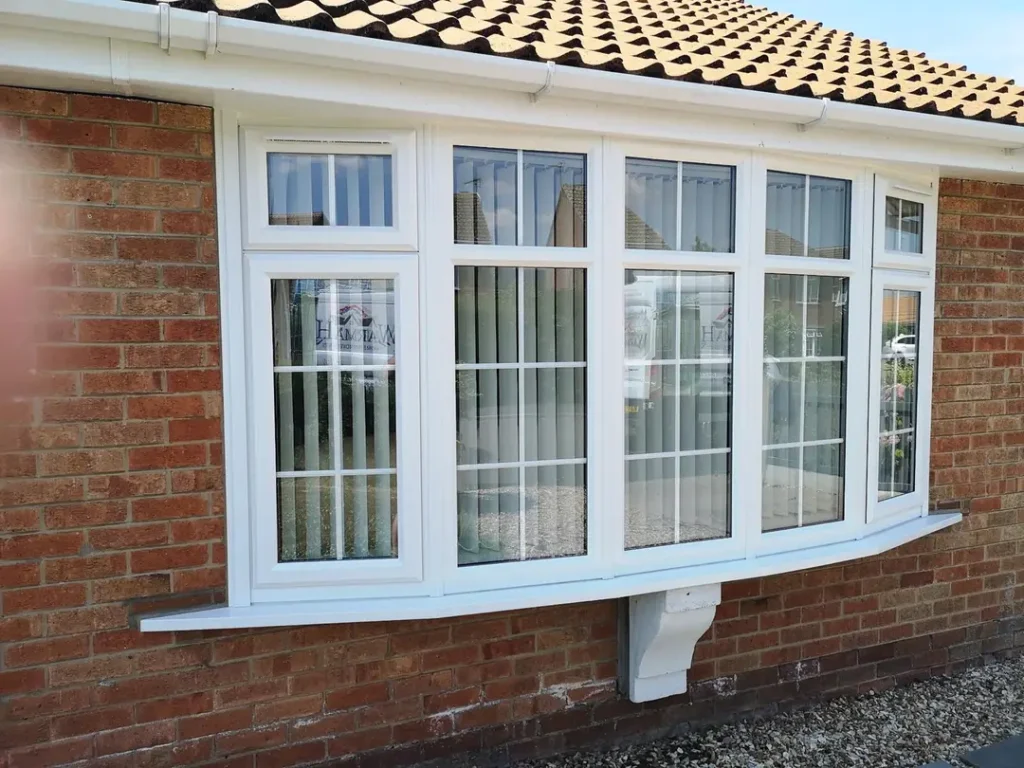 a white window on a brick building